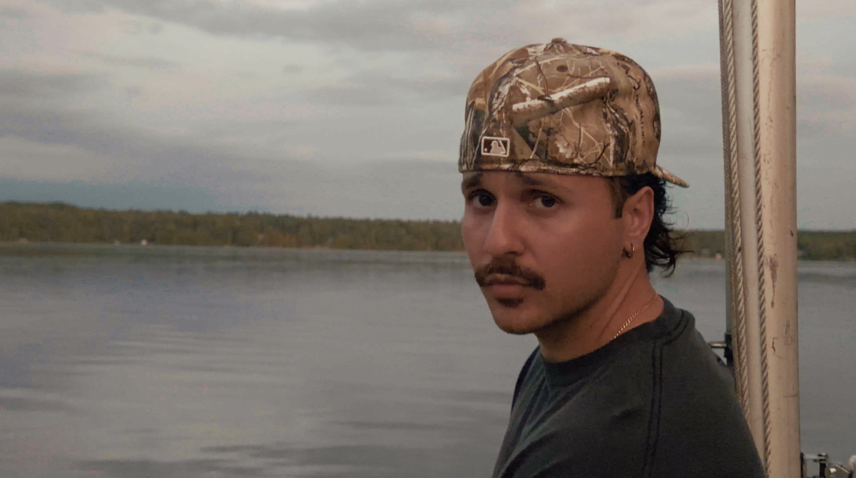 JOZY looking back over his shoulder from a boat on the water